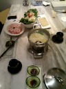 Having realized I lived in China for around six months without eating 
hotpot, I decided we should eat hotpot before we left the country.  We 
went to a reputable chain, Dollar Hot Pot.   The bulk of our order 
is shown in this picture: regular hotpot broth (center), tofu sheets 
(top-right), mixed leafy vegetables) (cabbage, spinach, and something 
else) (top-left), and lamb rib rolls (left).  The standard sauce in the 
square plate at left was a pleasing mix that included soy and something 
herby.  (It wasn't complex but I forget the details.)  As for the sauces 
at the bottom, see the next picture.

